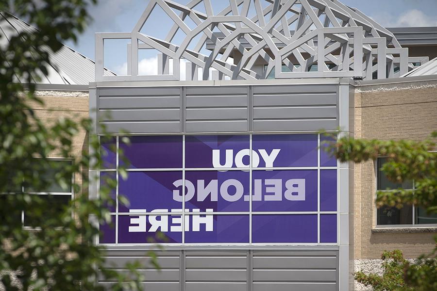 The exterior of the University Center with a purple window banner that says You Belong Here.